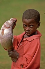 Boy shows his fish a